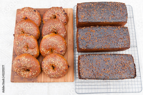 Whole grain bagels with sesame seeds and rye bread with coriande photo