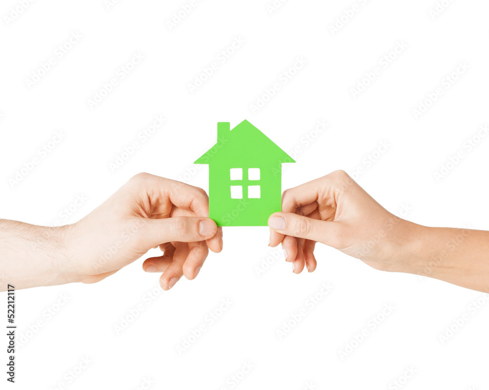 couple hands holding green house