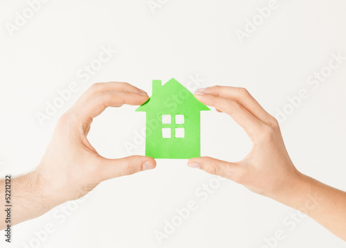 couple hands holding green house