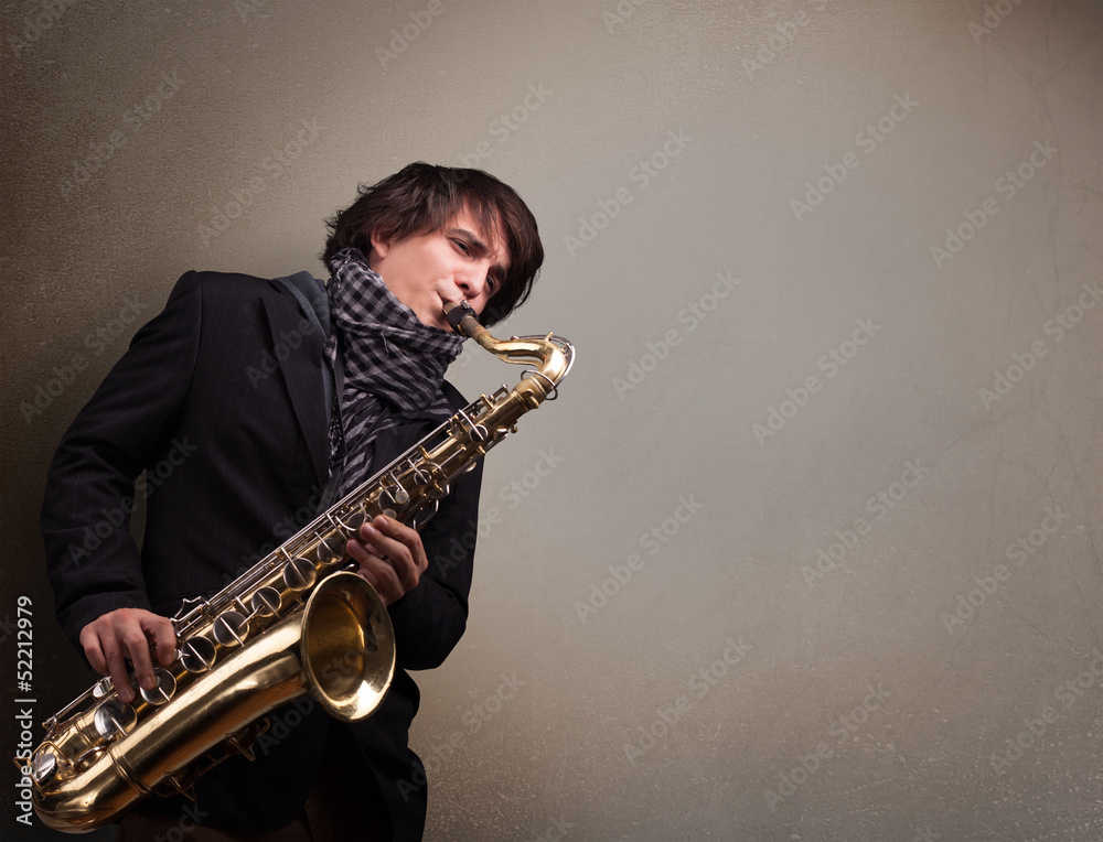 Naklejka premium Young musician playing on saxophone