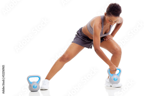 african woman exercising using kettle bell