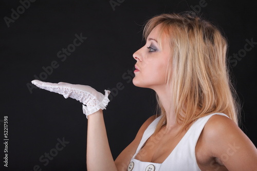 portrait beautiful woman blowing in white gloves