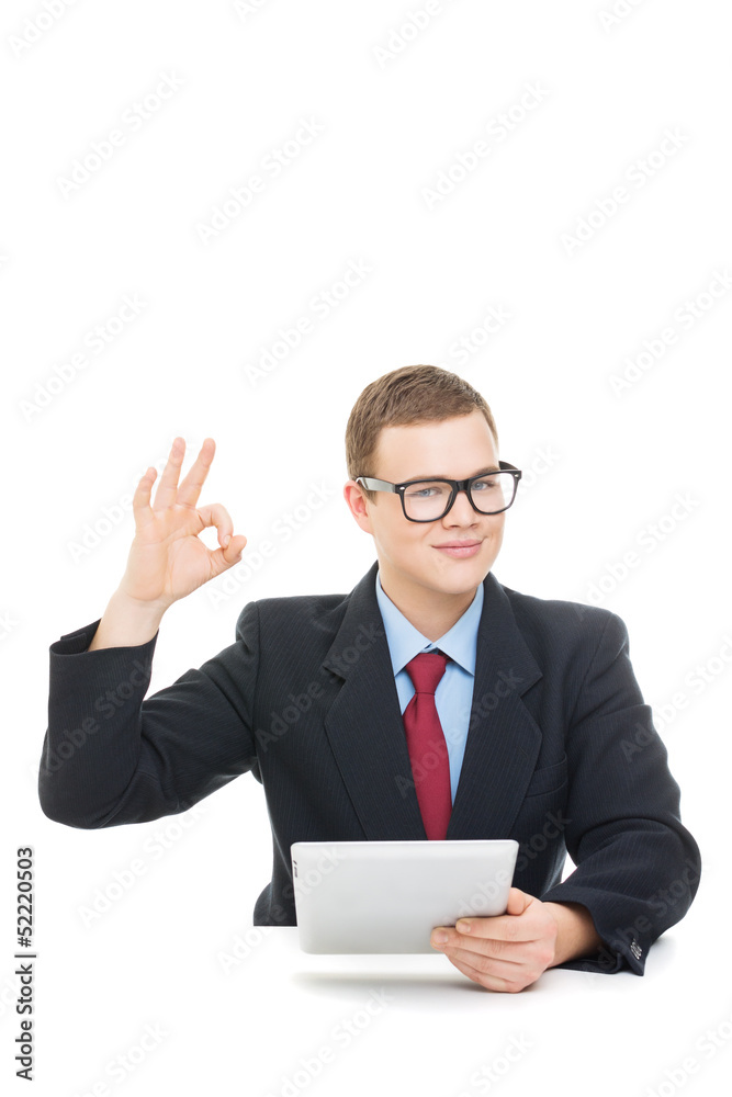 Happy businessman showing ok sign holding tablet computer Happy businessman showing ok sign holding tablet computer