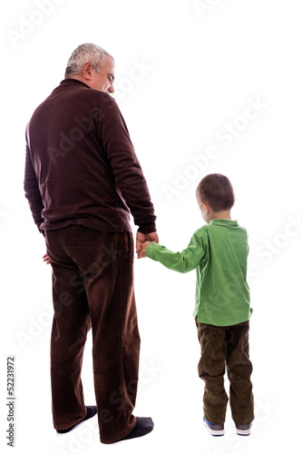 Senior man holding his grandson's hand, back view