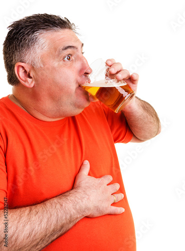 Portrait of an expressive fat man drinking beer