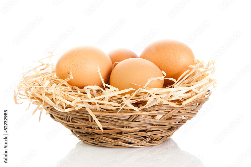 Brown eggs in the basket on white. Brown eggs in the basket on white.