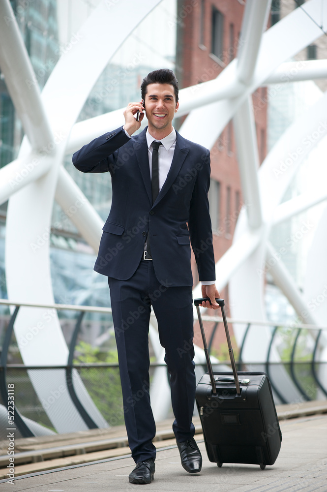 Confident businessman traveling with phone and bag Confident businessman traveling with phone and bag