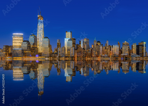 Lower Manhattan skyline at night reflected in water