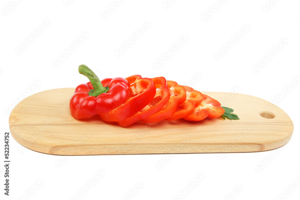 Red bell pepper sliced on a wooden cutting board. Red bell pepper sliced on a wooden cutting board.