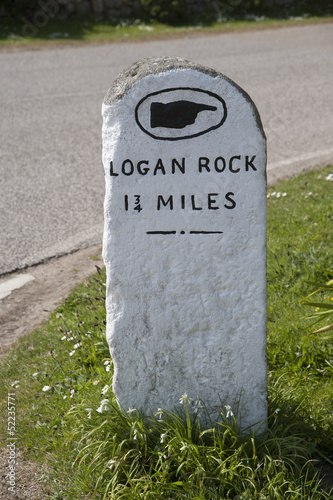 Milestone marker pointing to Logan Rock Cornwall England UK photo