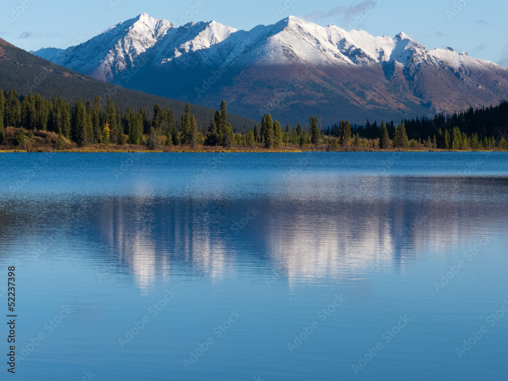 Snowcapped mountain reflection on Lapie Lake Yukon