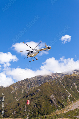 Transport helicopter fly over mountain wilderness