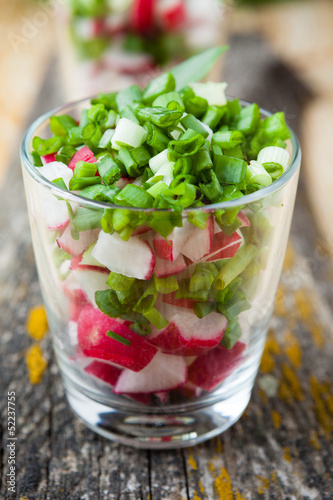vegetable salad with radish in transparent glass