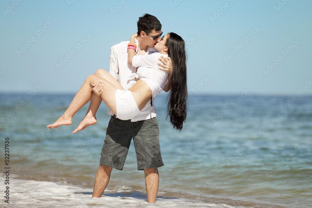 Beautiful couple kissing on the beach.