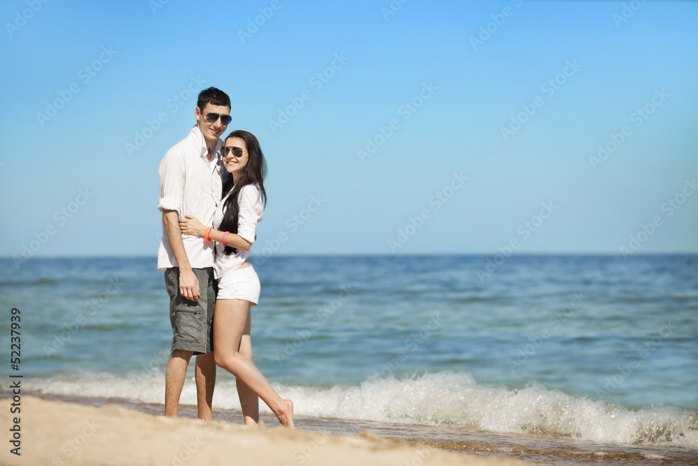 Beautiful couple kissing on the beach.