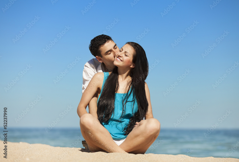 Beautiful couple kissing on the beach. Beautiful couple kissing on the beach.