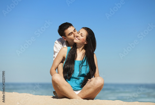 Beautiful couple kissing on the beach. © Masson