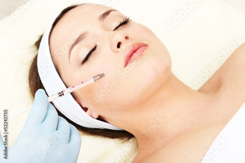 Young woman receiving plast...
