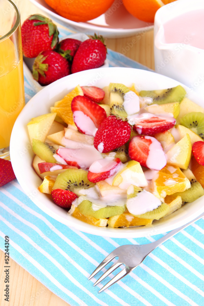 Useful fruit salad of fresh fruits and berries in bowl Useful fruit salad of fresh fruits and berries in bowl