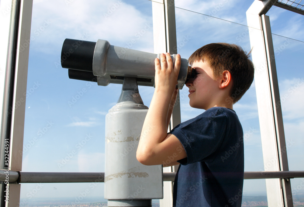 boy looking through binoculars