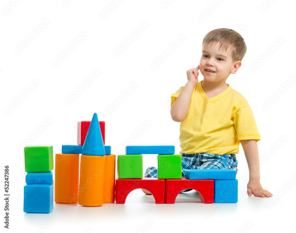 little boy is playing with colorful building blocks isolated on little boy is playing with colorful building blocks isolated on