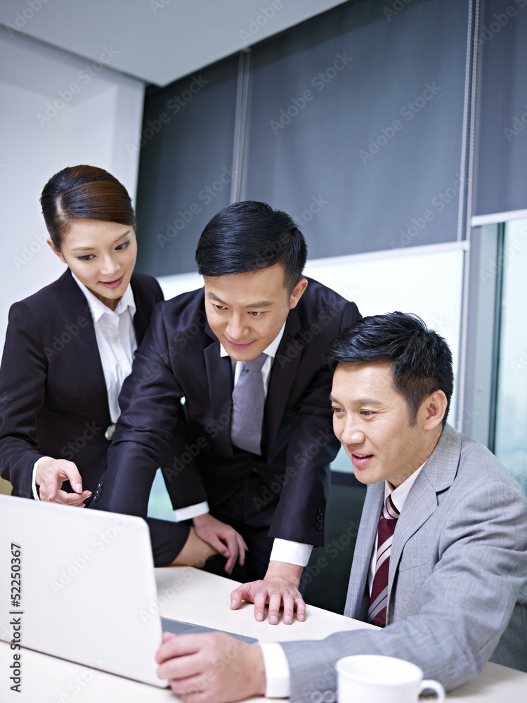 asian business team working together in office asian business team working together in office