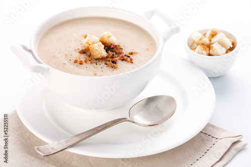 Cauliflower soup with croutons on white background