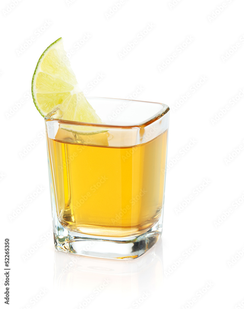 Shot of gold tequila with lime slice Shot of gold tequila with lime slice