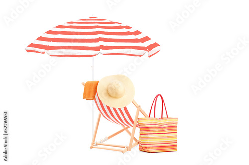 Fotografie, Obraz Sun lounger with orange stripes, umrella and summer accessories