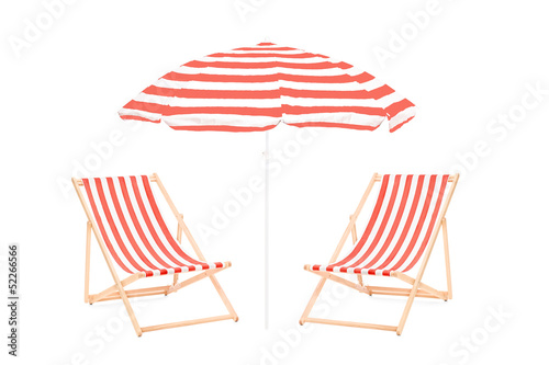 Fototapeta Two beach sun loungers and an umbrella