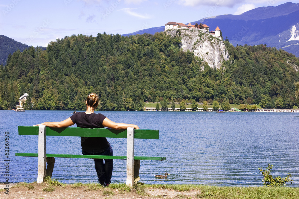 Woman on Bench, enjoys summer day in Bled Lake, Slovenia