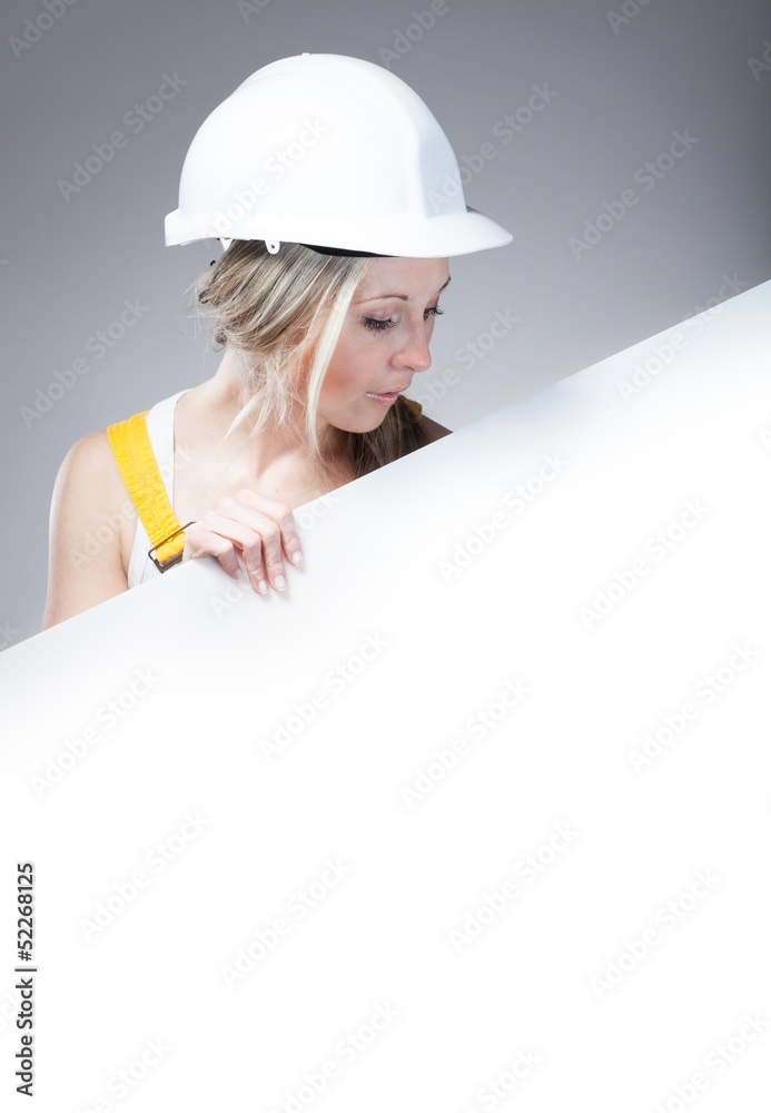 Young builder woman construction worker, empty banner Young builder woman construction worker, empty banner