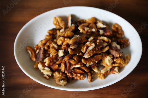 Walnuts, shelled fruit on white plate, food ingredient