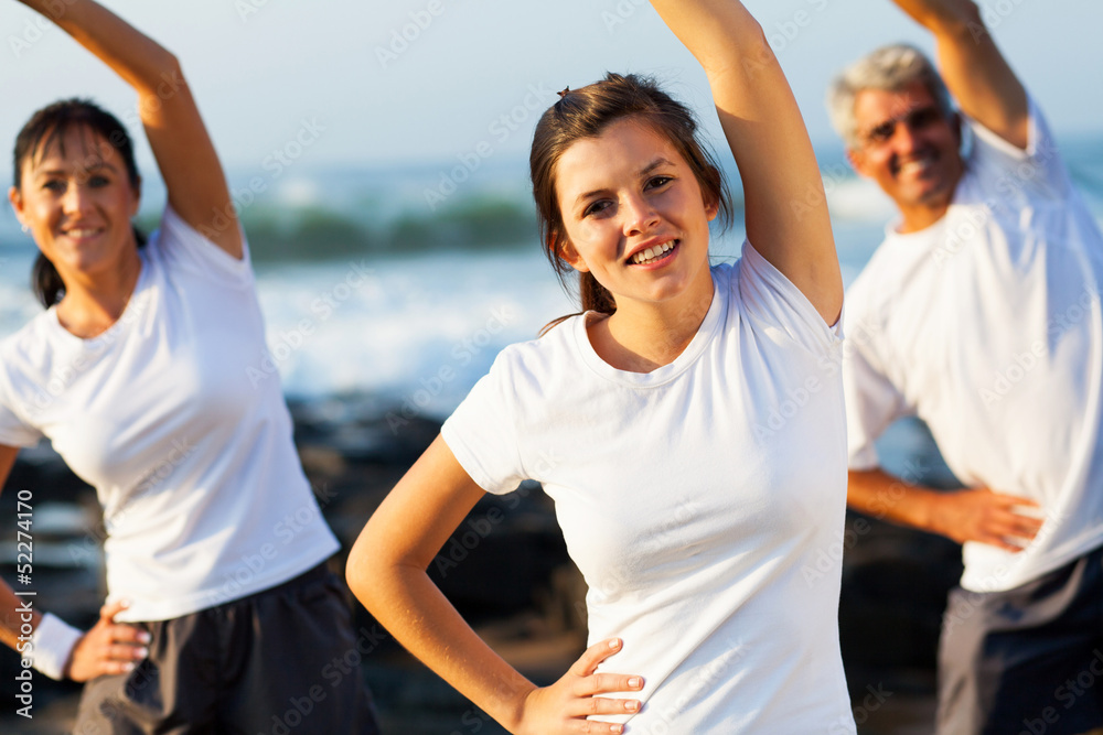 teenage girl and her parents working out at the beach teenage girl and her parents working out at the beach