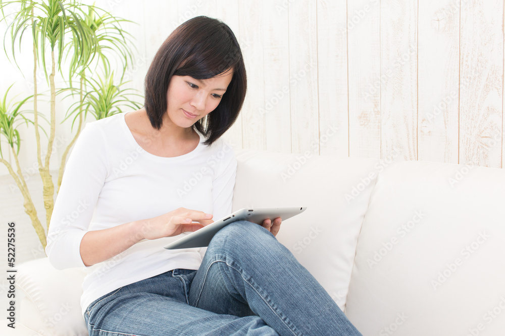 beautiful asian woman using tablet computer beautiful asian woman using tablet computer