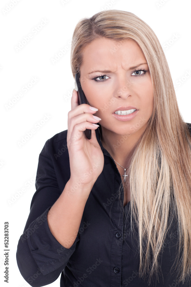 Worried young blond woman talking on mobile phone Worried young blond woman talking on mobile phone