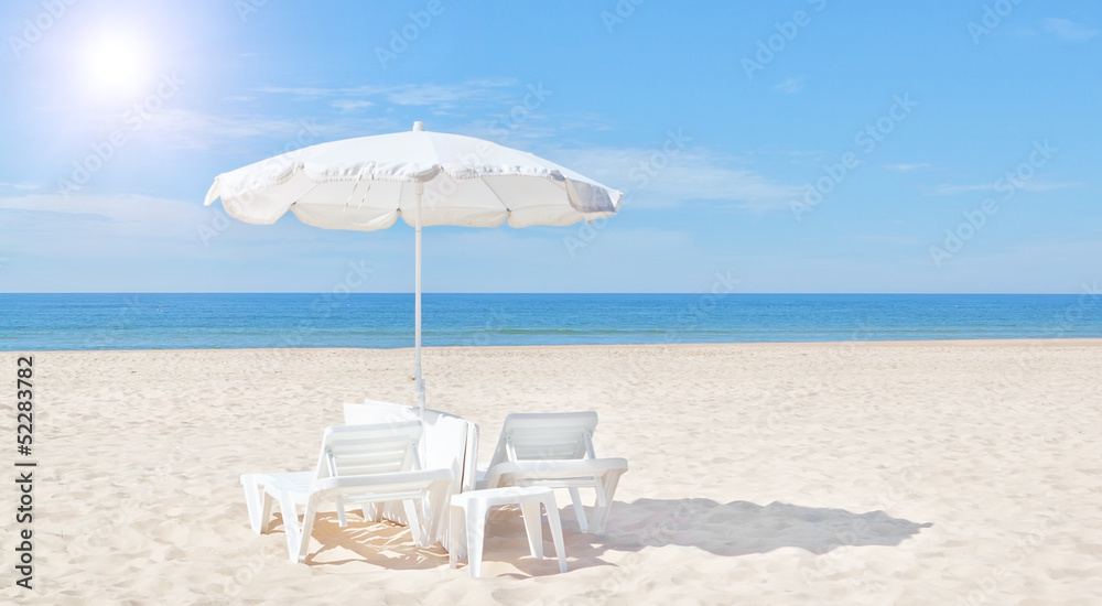 Beautiful white beach umbrella and sun bed on the beach. For the foto