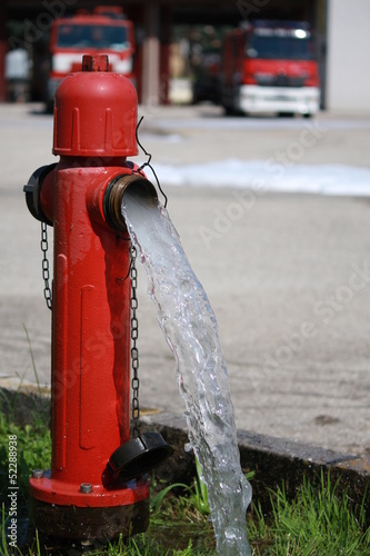 powerful water flow coming out with impetus from a street red hy