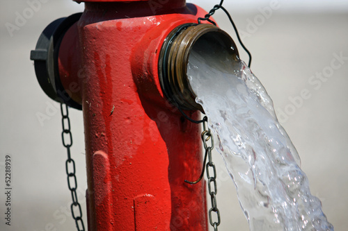 powerful water flow coming out with impetus from a street hydran