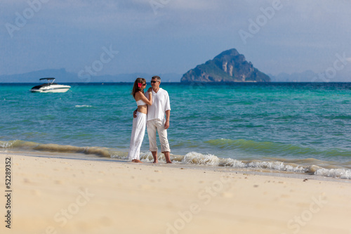couple in white on the beach