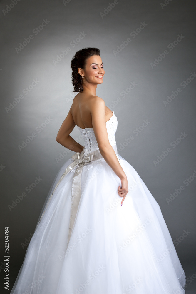 Cheerful model posing in wedding dress, close-up