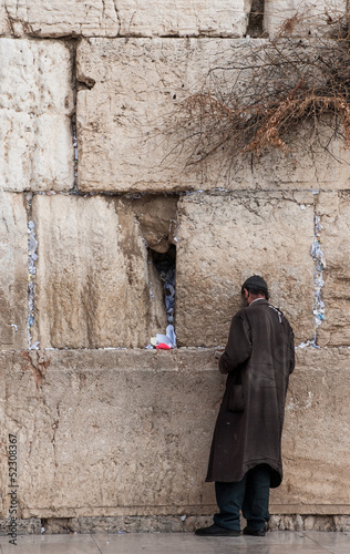 A poor man praying at the Wailing wall, Jerusalem, Israel.