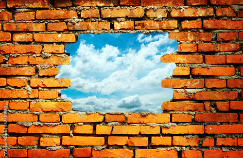 Fototapeta Naklejka Na Ścianę i Meble -  porous wall to see the blue sky