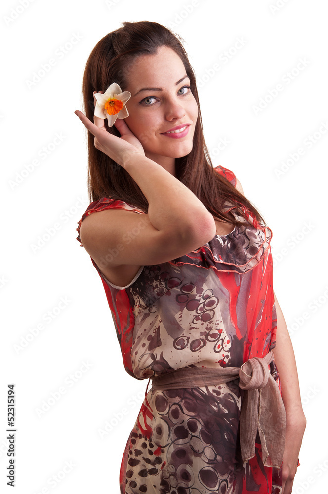 Attractive young beautiful woman smiles and puts a daffodil in h Attractive young beautiful woman smiles and puts a daffodil in h