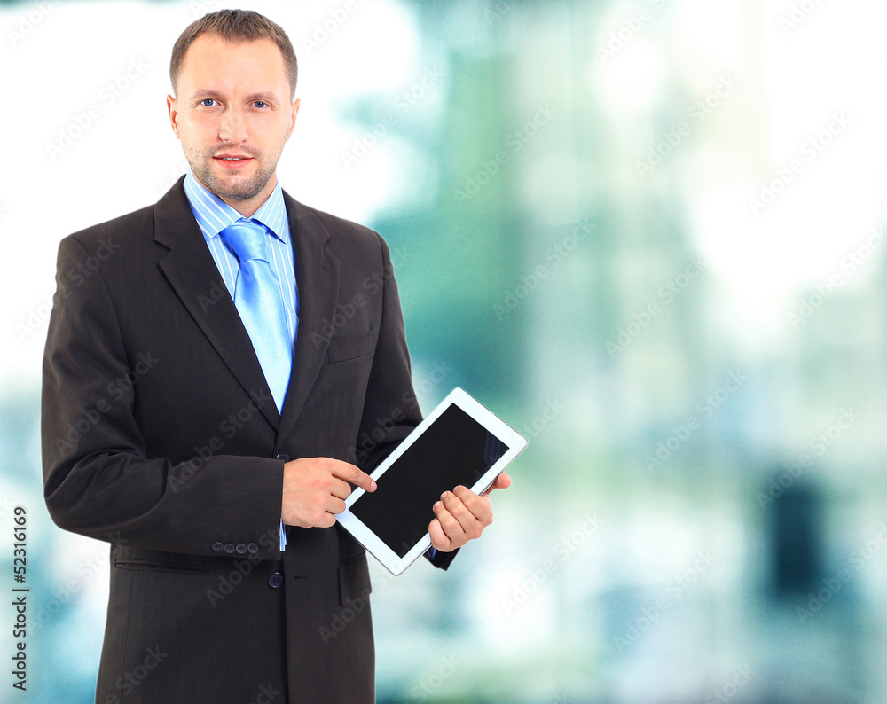 Portrait of a young office worker using a tablet computer Portrait of a young office worker using a tablet computer