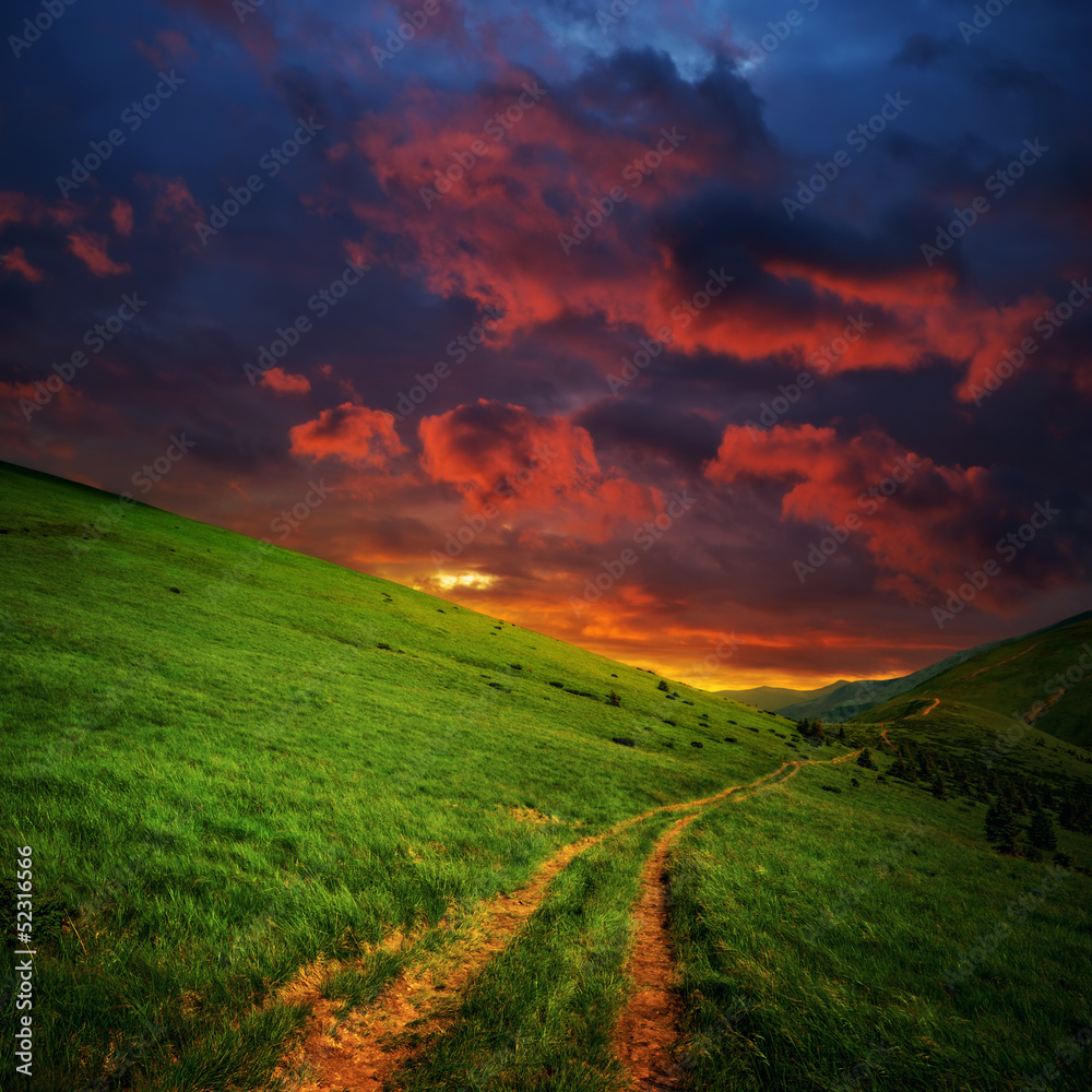 Obraz premium hills and road to red clouds