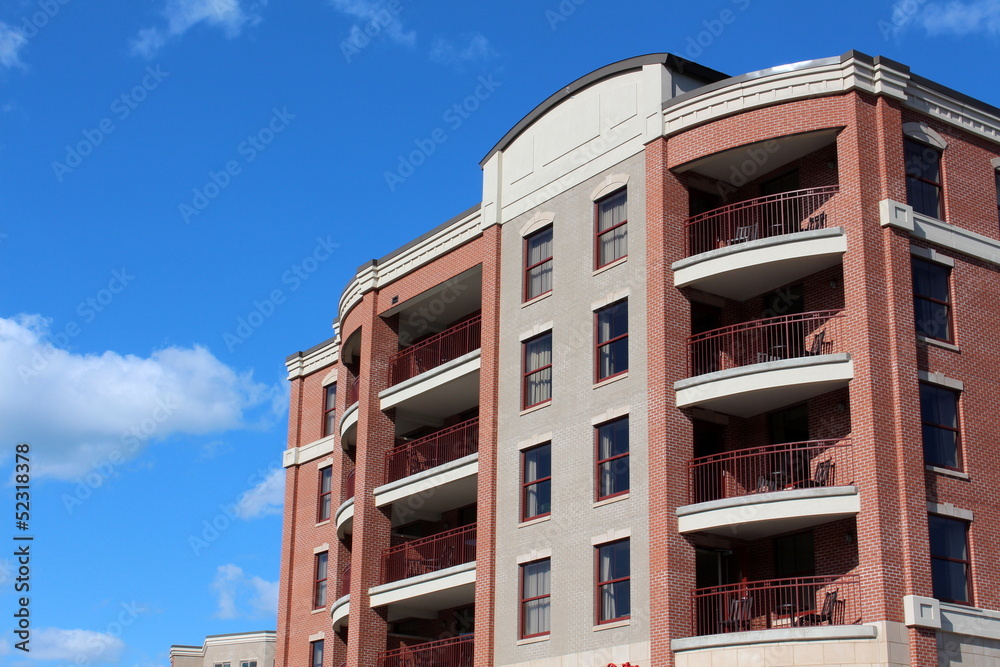 Stone and brick building with open patios on each floor Stone and brick building with open patios on each floor