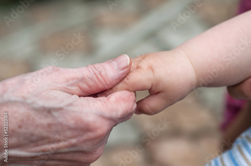 hands of baby grandson and old grandmother, concept of family re © axentevlad