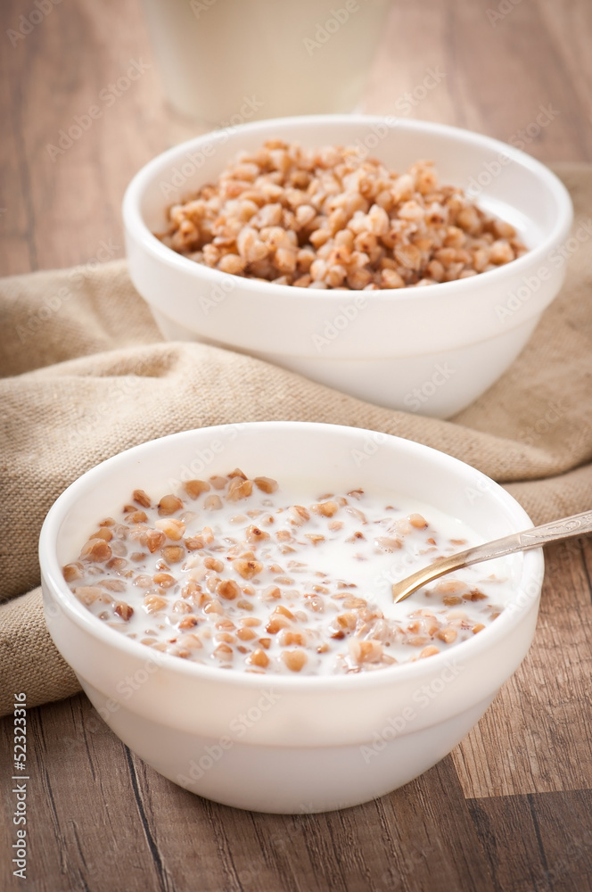 Buckwheat porridge with milk on a wooden table Buckwheat porridge with milk on a wooden table