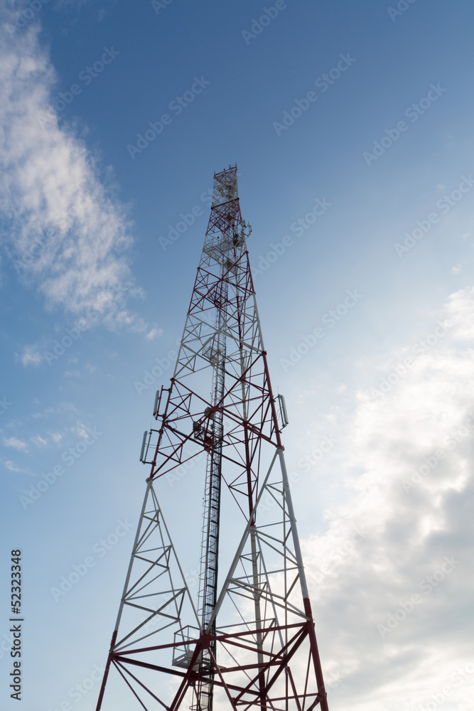 Communications tower against a blue sky with clouds. Communications tower against a blue sky with clouds.